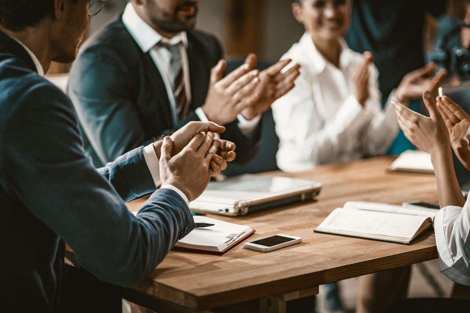 Decision-makers in a real UK workplace or boardroom. Human and considered.