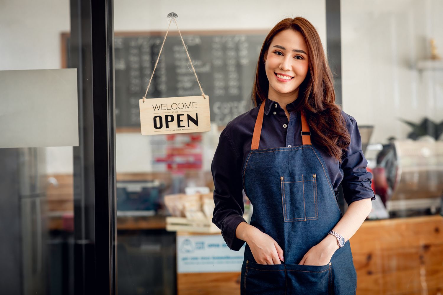 A small business owner with a postcard, or a local high street. Warm and human.
