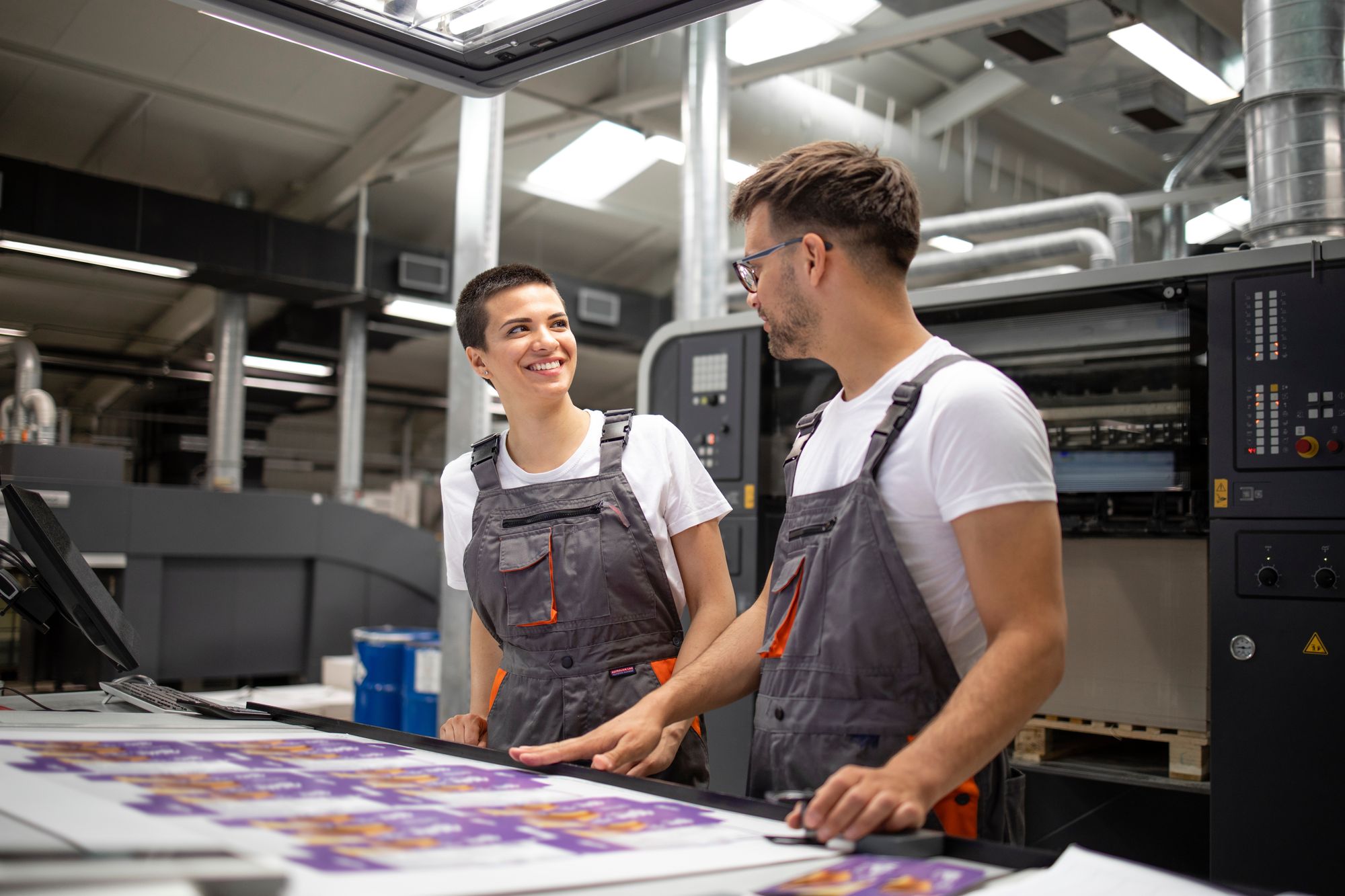 A wide editorial shot: print and mail production, or an agency workspace.