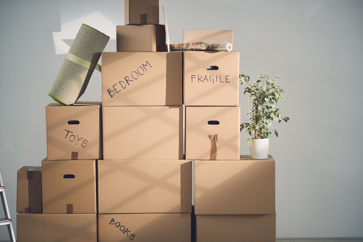 A family mid-move, boxes at a UK front door. Warm and real.