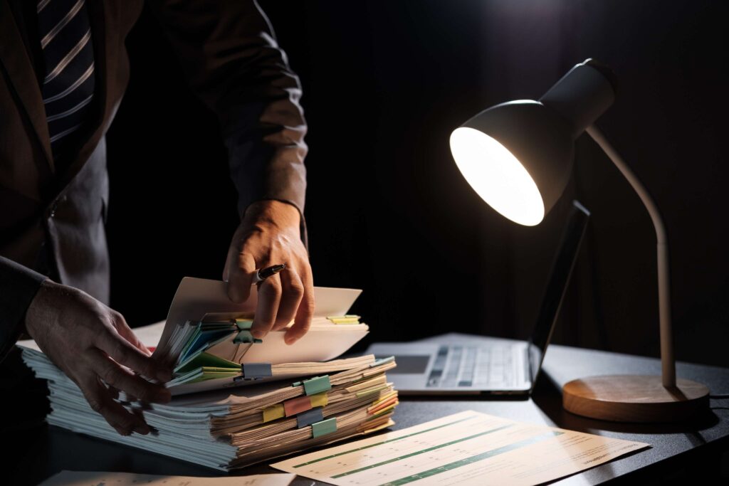 Business employee hand working in stacks paper fil 2026 03 16 23 03 34 utc (1)