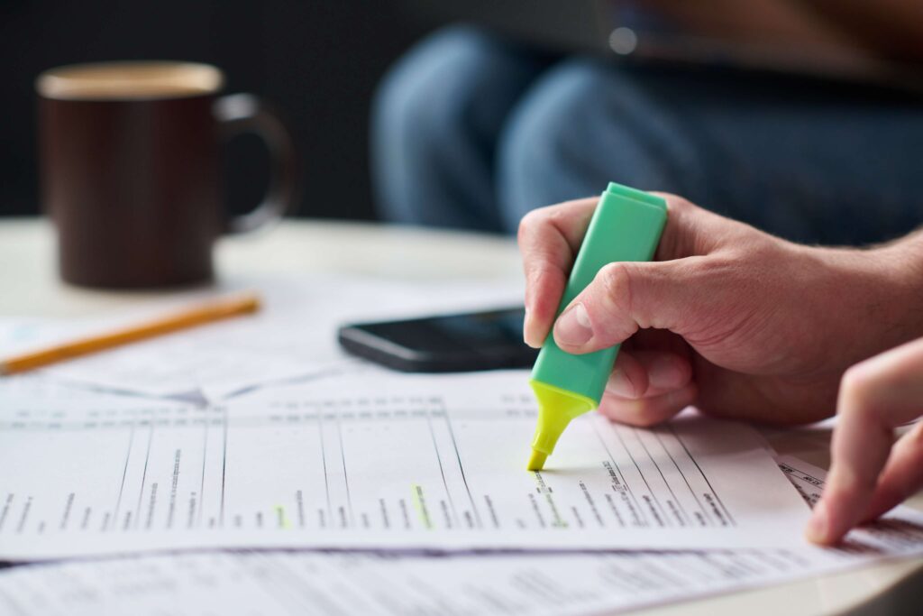 Caucasian young adult man highlighting tax documen 2026 03 26 23 29 31 utc (1)